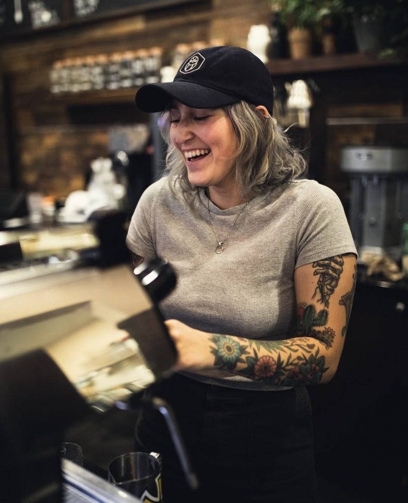 barista smiling at the espresso machine