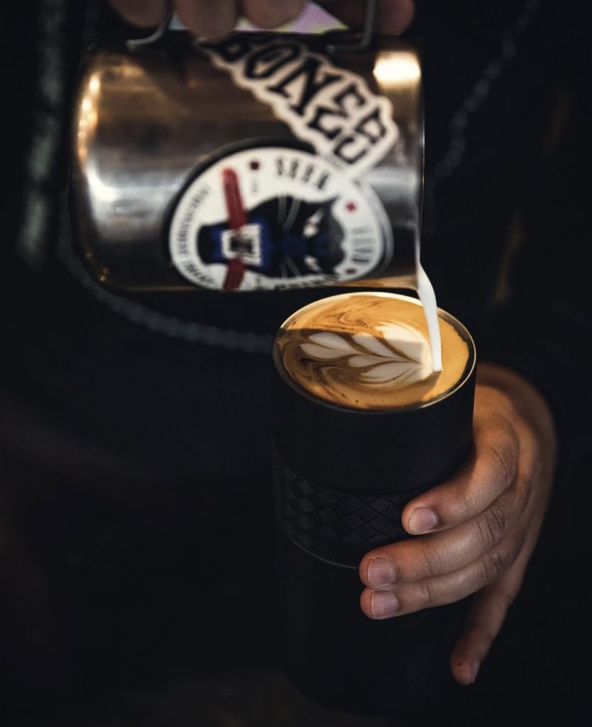 barista making hot latte
