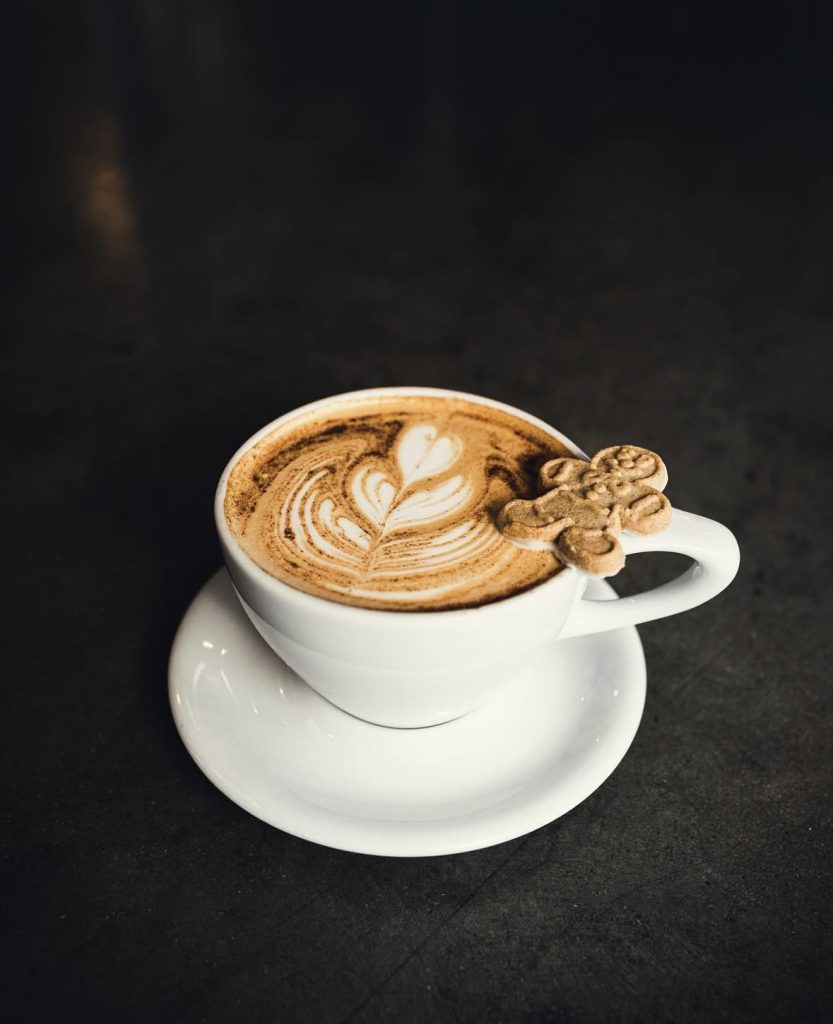 large mug with coffee and gingerbread cookie